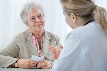 Elderly woman discussing cataracts with a doctor