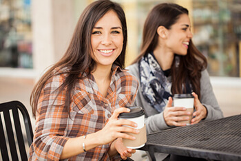 Young woman enjoying coffee after LASIK