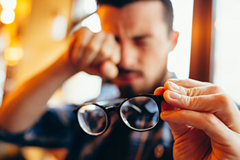 Man with glasses struggling with monovision