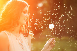 Girl looking at flower after receiving LASIK Eye Surgery