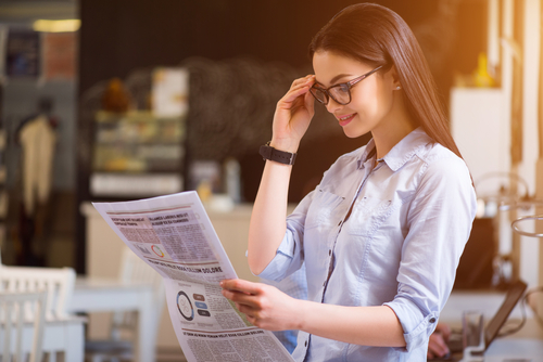 Woman with glasses reading about LASIK